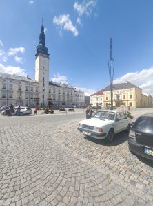 Škoda 120L and Pavel standing in front of the Town hall of Litovel city.